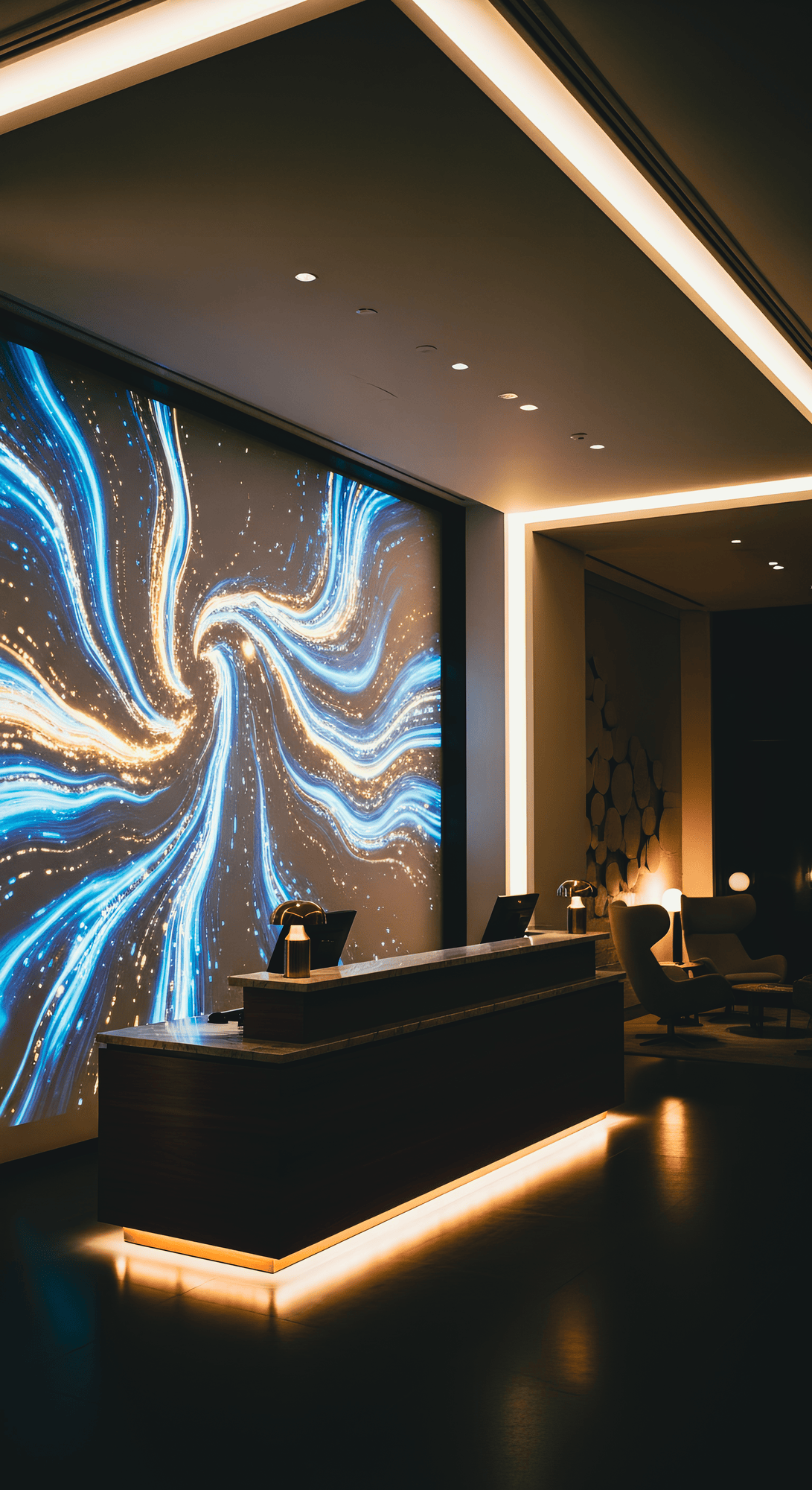 Modern reception area with sleek desk and futuristic artwork. The wall displays swirling blue and white light patterns, creating a dynamic, welcoming vibe.