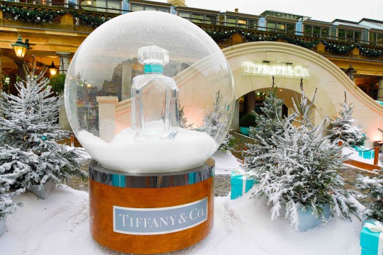 Large, life-size Tiffany & Co branded snow globe surrounded by snow, at Covent Garden in London.